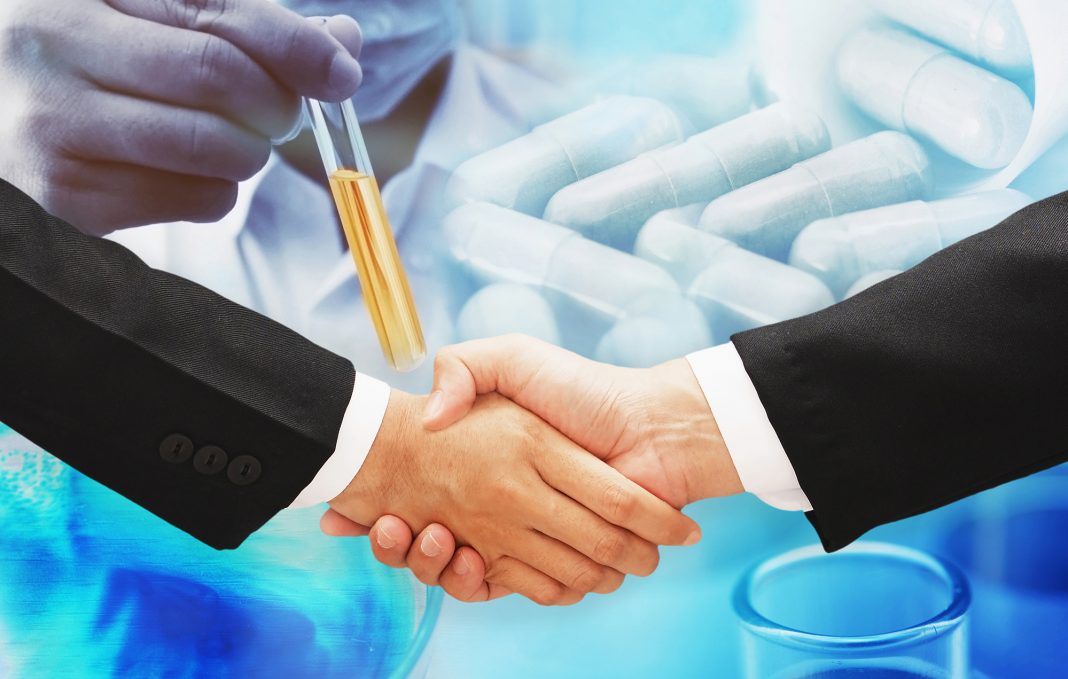 business man hand shake with science research blur background
