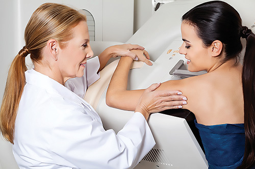 Doctor Assisting Patient During Mammography