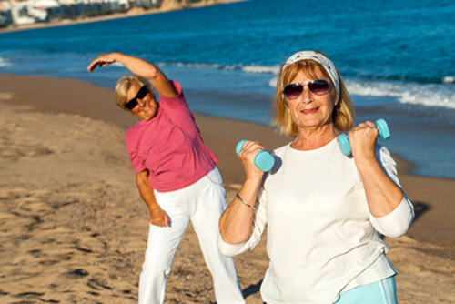 elderly exercising on the beach