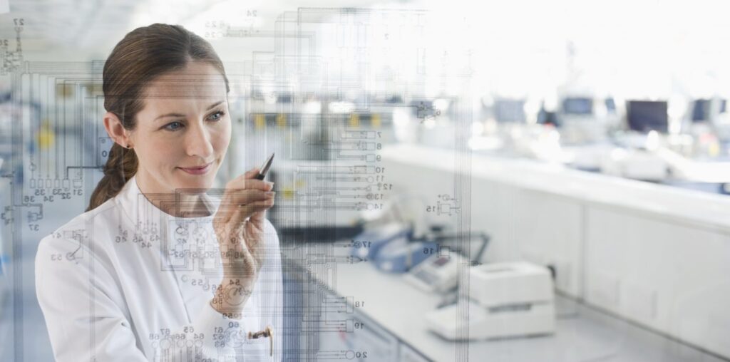 Female scientist using touch screen in lab