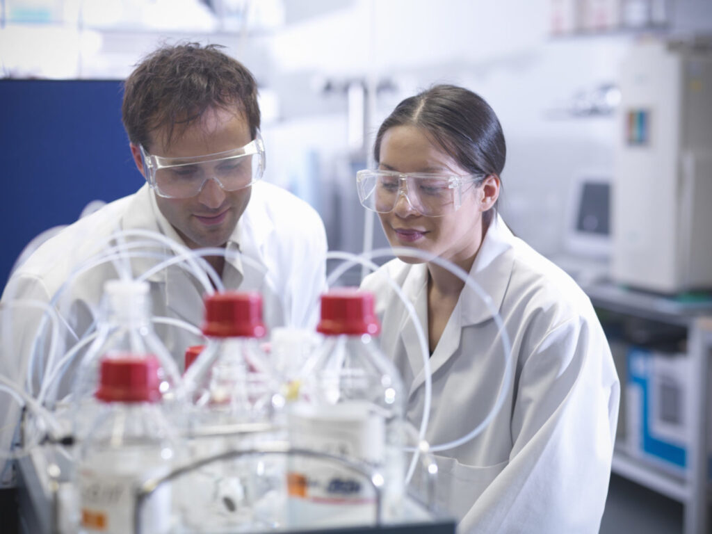 Scientists looking at protein samples, readying for mass spectrometry in biolab