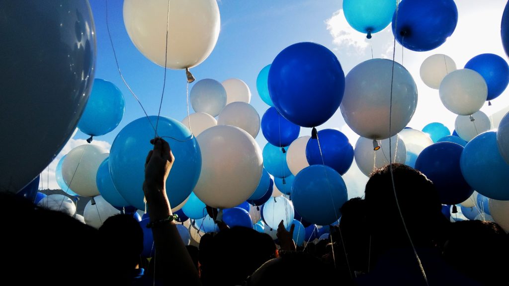 People Holding Balloons