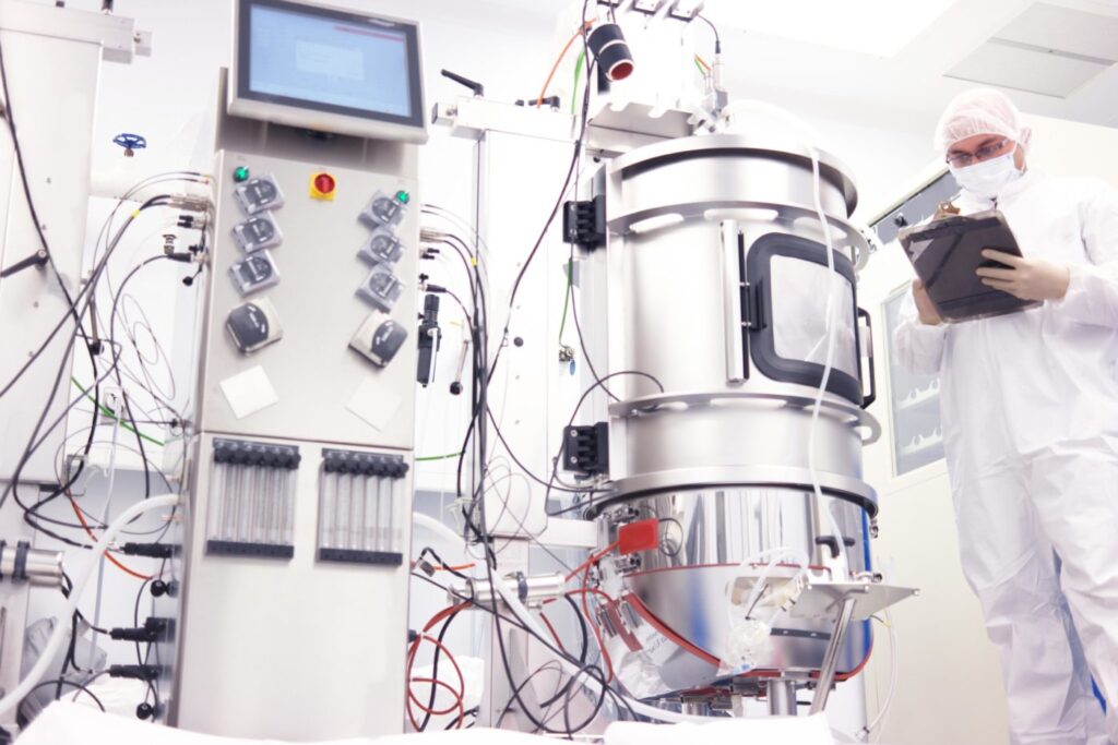 scientist with bioreactor