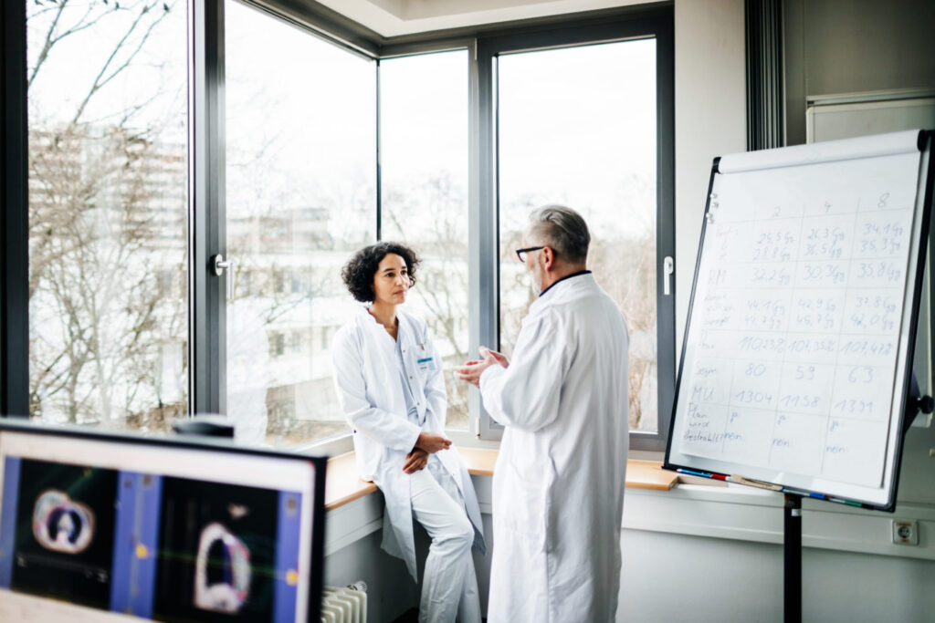 Two Doctors Discussing Test Results In The Lab