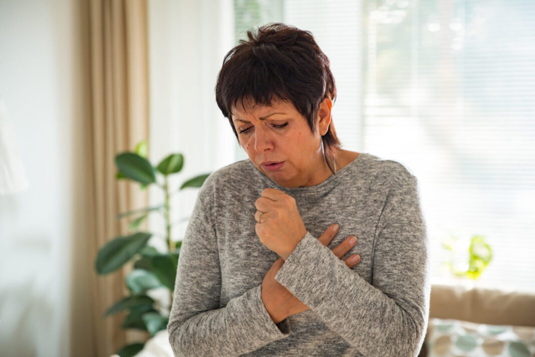 Sick mature woman with sore throat