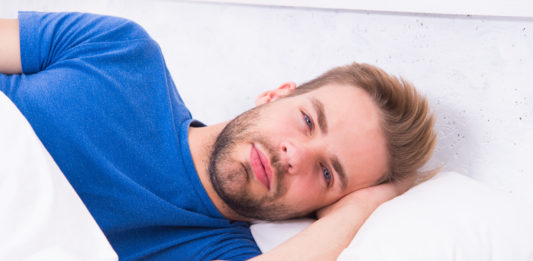 Tips sleeping better. Maintaining consistent circadian rhythm is essential for general health. Man handsome guy sleeping. Get enough amount of sleep every night. Bearded man sleeping face relaxing