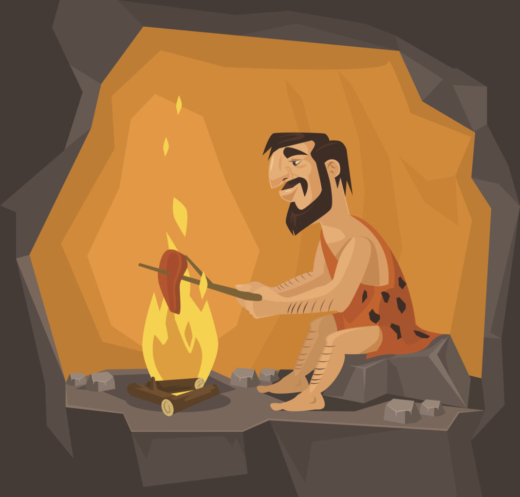 Caveman is cooking in cave. Vector flat illustration