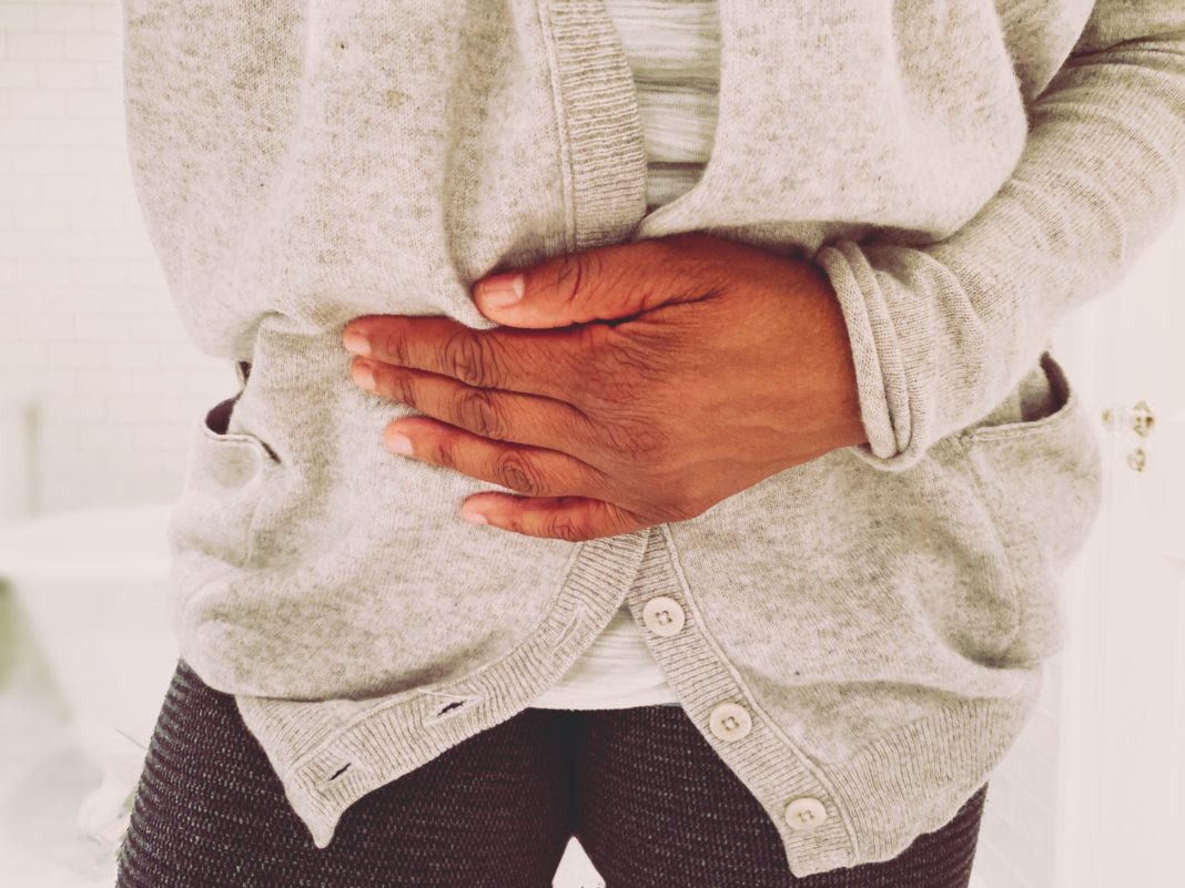 african-american woman experiences stomach pain
