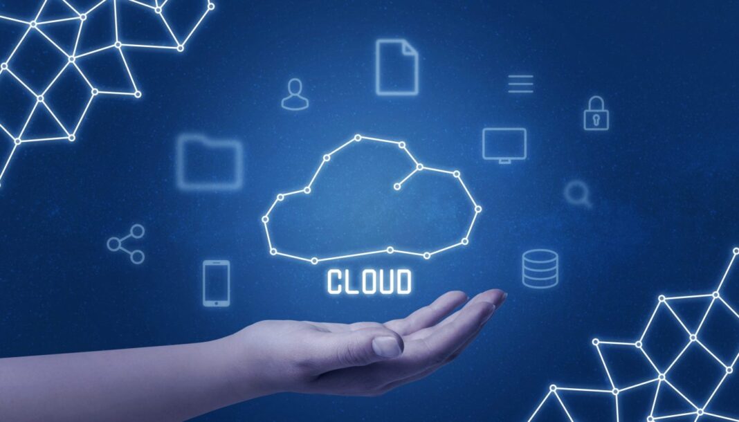 Cloud computing concept with cloud drawing in hand surrounded with tehnology icons.