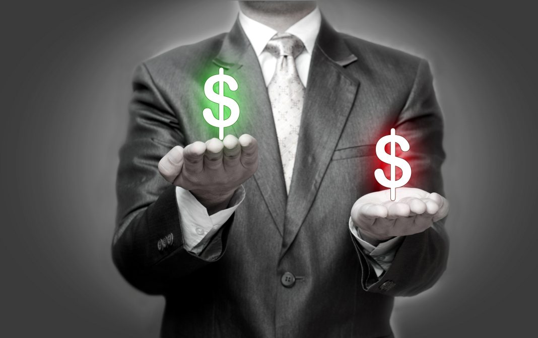 Businessman Holding Dollar Symbols green and red