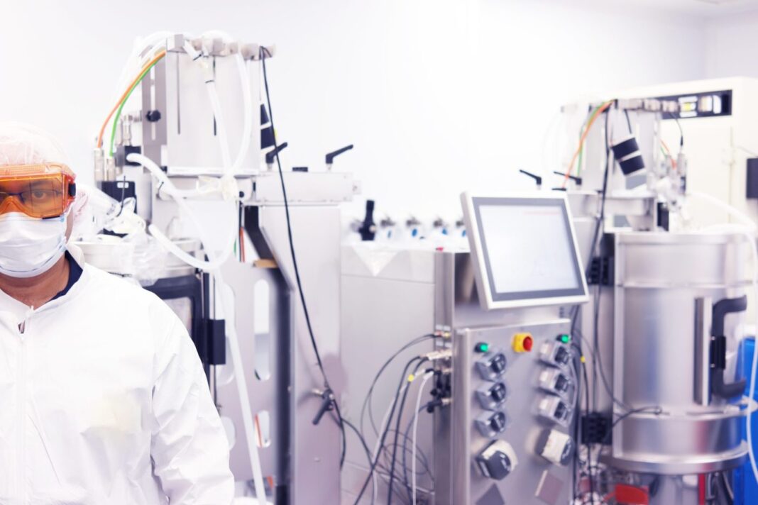 scientist with bioreactor