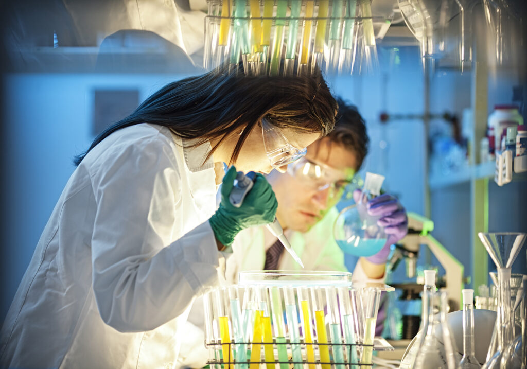 scientist, doctor, assistant working at the laboratory using pipette