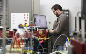 ISIS Scientist and lead author, Dr Luke Clifton operating the advanced Offspec instrument at the ISIS Neutron and Muon Centre in Oxfordshire that produced real time images of processes taking place inside cells for the study.