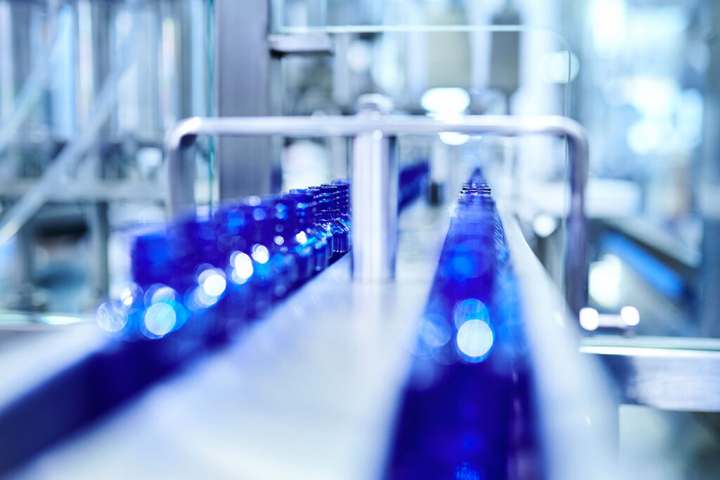 Blue Bottle at Filling in Conveyor Belt