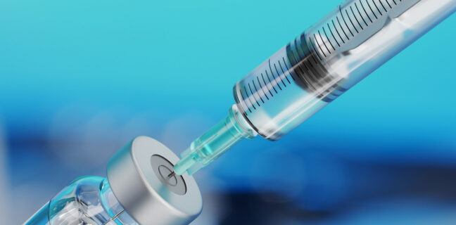 Medical disposable syringe for vaccine injection and glass vial.