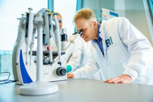 Cellular Intelligence employee with microscope