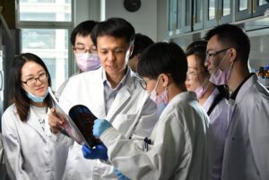 Guangjun Nie, PhD, professor at the National Center for Nanoscience and Technology, Beijing, China, with his team of scientists in the lab. [Guangjun Nie]