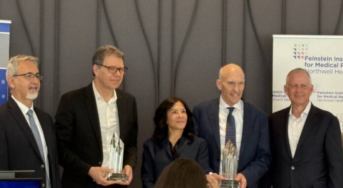 An image showing the two honorees receiving their awards at an event to celebrate the 13th annual Ross Prize in Molecular Medicine [Uduak Thomas].