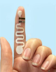 Levodopa monitoring patch showing the assembly of the hydrogel and levodopa sensor with the paper fluidic channel on the fingertip. [Tamoghna Saha.]
